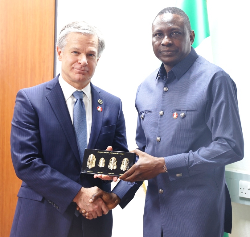L-R: Director, FBI, Christopher Wray in a warm handshake with the Executive Chairman, EFCC, Mr. Ola Olukoyede
