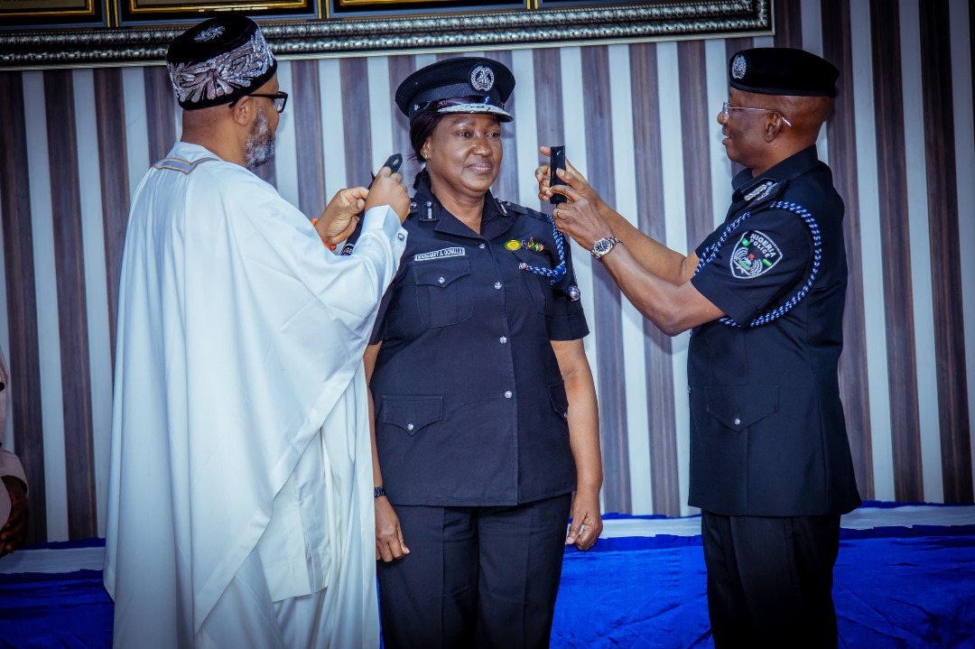 R-L: Inspector-General of Police, Nigeria Police Force, IGP Kayode Egbetokun decorating the newly promoted Assistant Inspector General of Police, AIG Margaret Agebe Ochalla supported by the AIG Ochalla's Husband at the Force Headquarters, Abuja. 