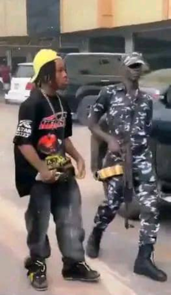 Police officer performing guard duty to a young man 