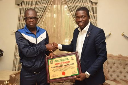 Governorship Candidate, People Democratic Party, PDP, Chief Agboola Alfred Ajayi receiving NAOSNP Certificate of Credence from the President, National Association of Online Security News Publishers, NAOSNP, Oki O. Samson during NAOSNP President's courtesy visit to Chief Agboola Ajayi at his resident in Akure and Security Assessment Tour to Ondo State ahead of the November 16th Ondo State Gubernatorial election. 