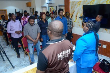 Coverner, Symphony of Praise and Worship, SPAW Concert, Dr. Ajokesings with the Head of Department, Department of Music and Sound Production, University of Lagos, UNILAG, Prof. Albert Oikelome and the Final Year Music Students of UNILAG observing the National Anthem during the Music Business with Dr. Ajokesings - an interactive session with the Final Year Music Students of UNILAG held at the Executive Hotel and Suites Event Center, Ogba Lagos...